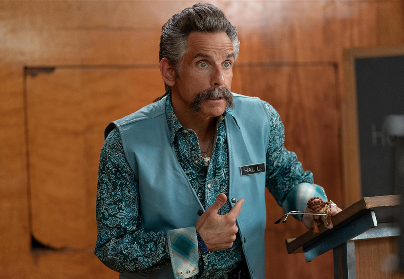 A person with a mustache and a blue vest

AI-generated content may be incorrect.