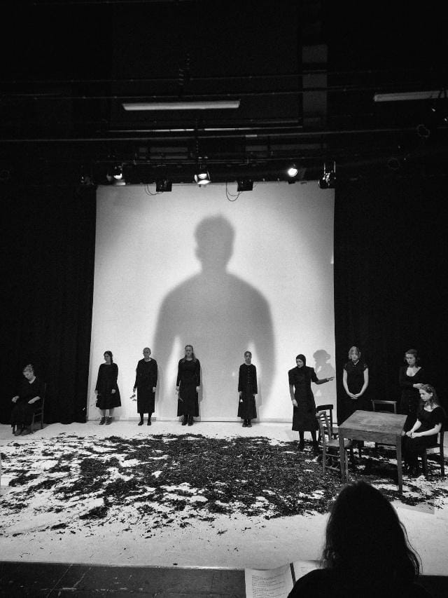 A group of people standing in front of a large shadow
AI-generated content may be incorrect.