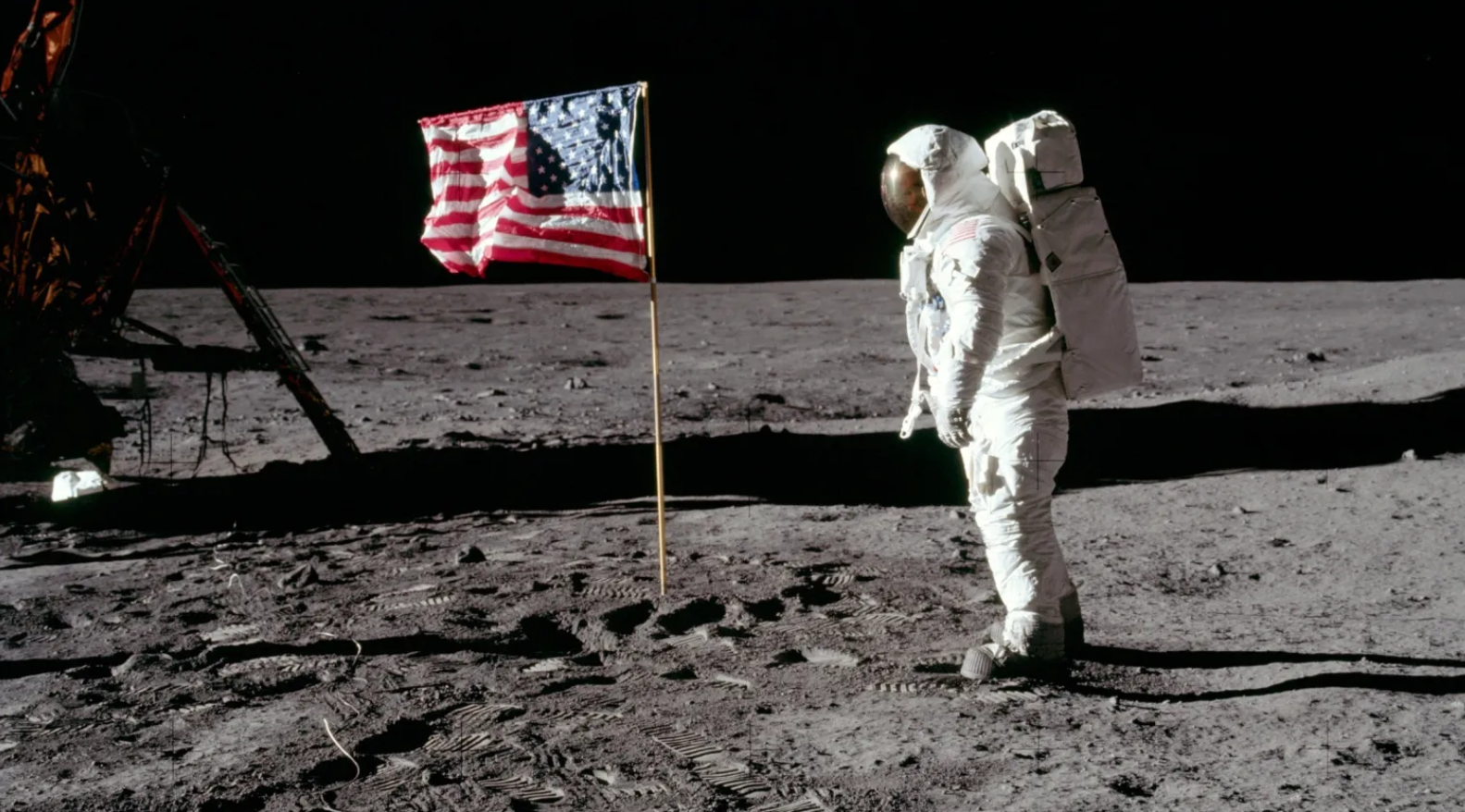 A person in a white suit standing on the moon with a flag

AI-generated content may be incorrect.