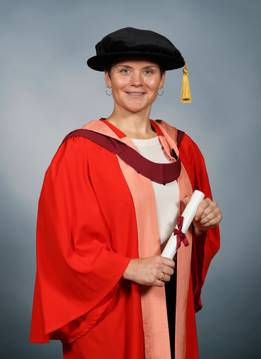 A person wearing a graduation gown and hat

AI-generated content may be incorrect.